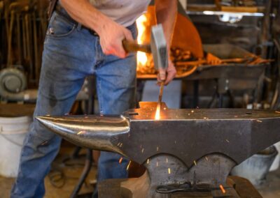 Blacksmith striking iron on an anvil