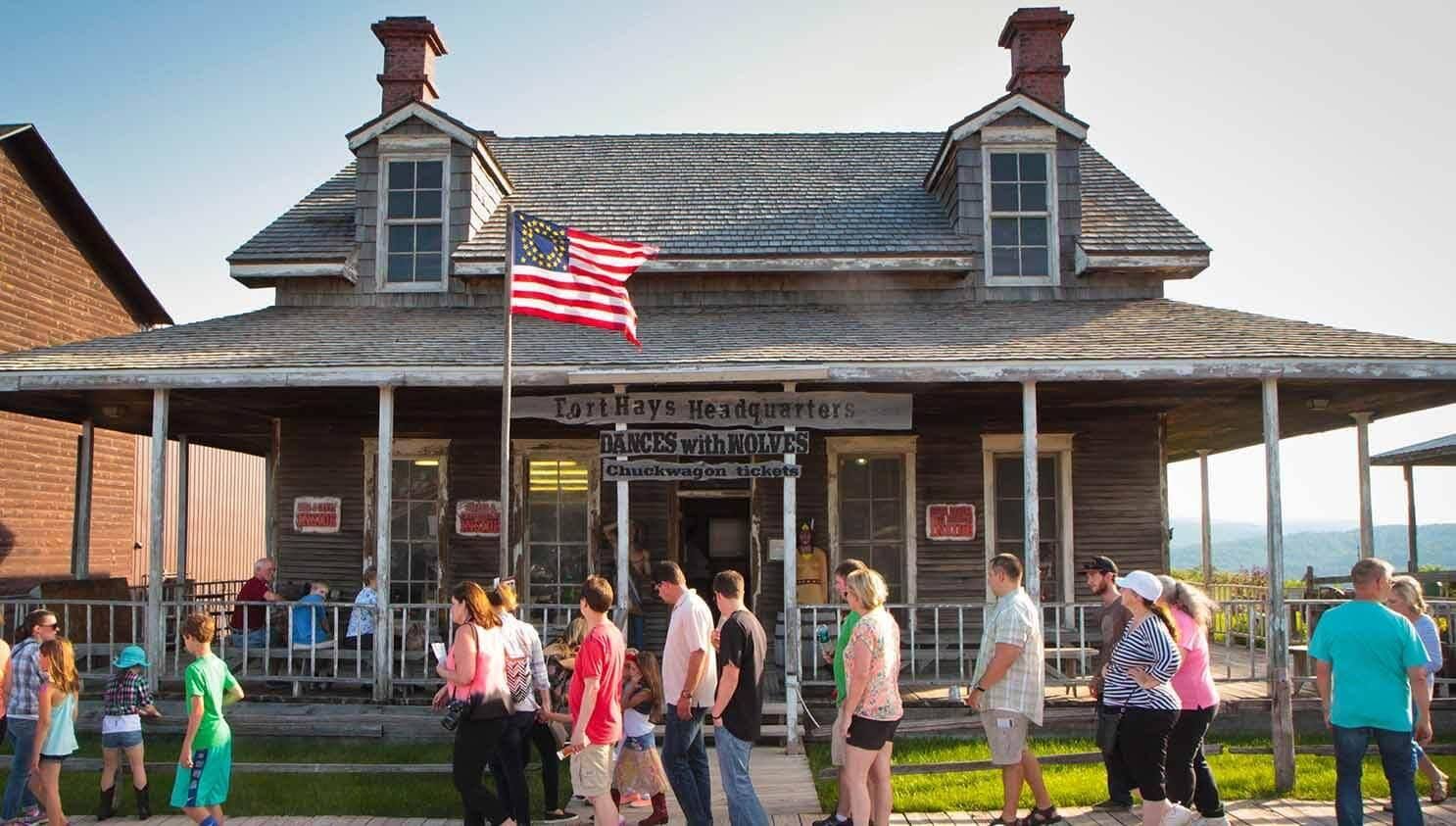 Family approaching the entrance of Fort Hays Old West Town