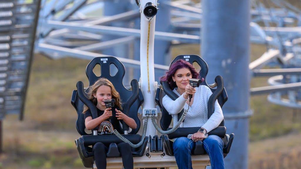Family smiling as they shoot targets