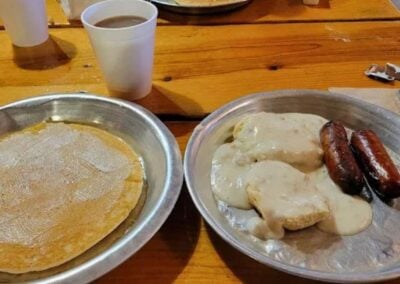 Pancakes on tin plates served inside the Chuckwagon Hall