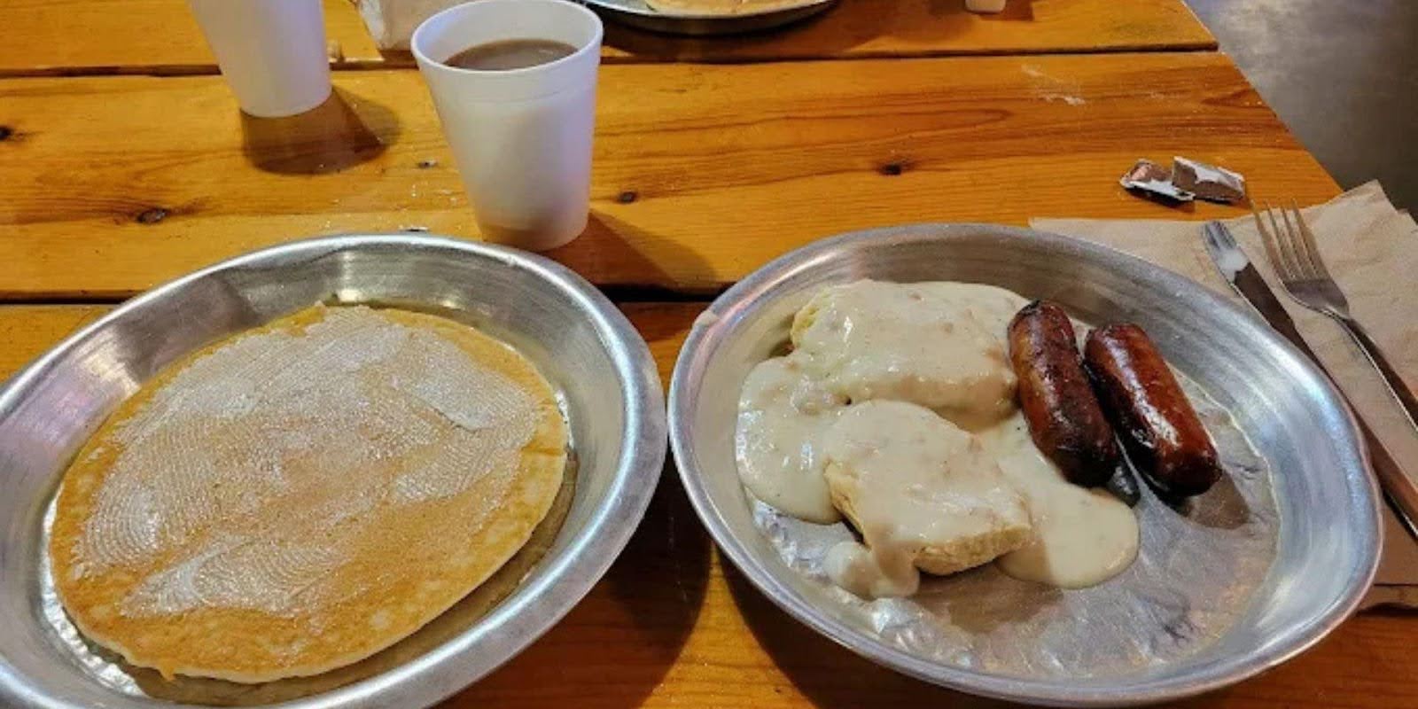 Pancakes on tin plates served inside the Chuckwagon Hall