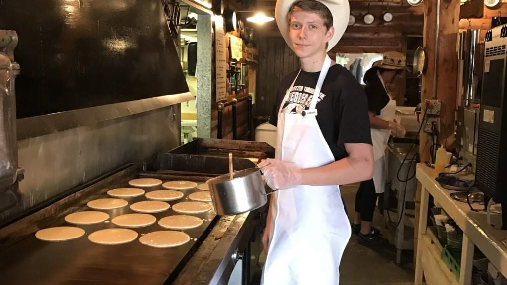 pancakes being cooked on a griddle 